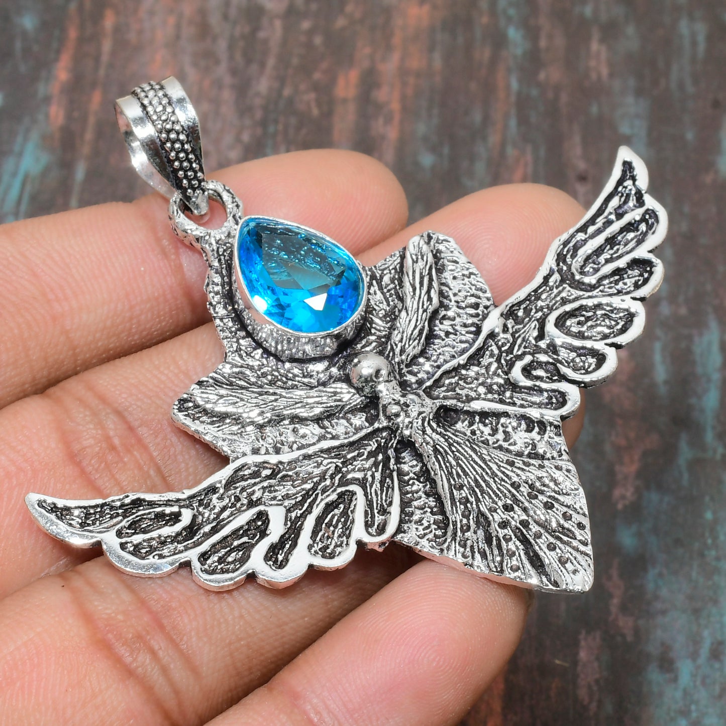 Celestial Whisper – Blue Topaz & Silver Butterfly Pendant
