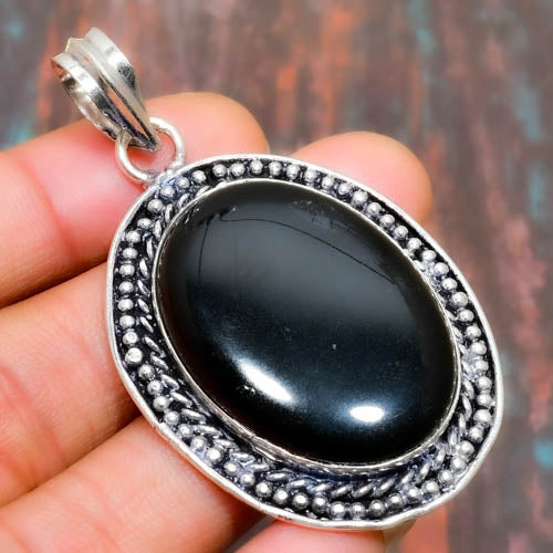 Obsidian’s Embrace – Sterling Silver Guardian Pendant