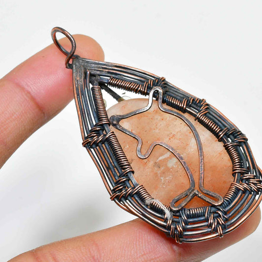 Dolphin’s Embrace – Peach Quartz Copper Pendant